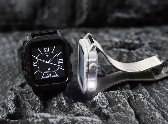 Rugged square smartwatches with a built-in flashlight resting on dark rock